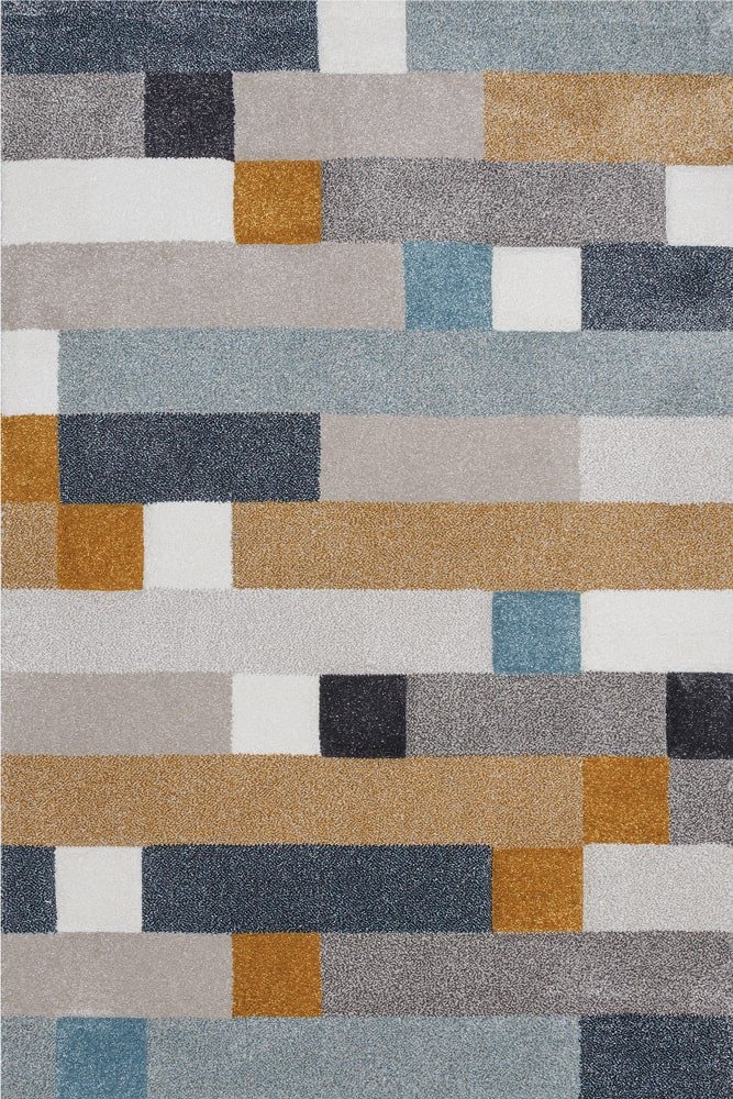 Sintelon tepih Vegas Home 62YKE Sintelon tepih Vegas Home 62 YKE – geometrijski dezen sa smjenjujućim pravougaonim poljima u sivim, bež, plavim, bijelim i žutim tonovima.